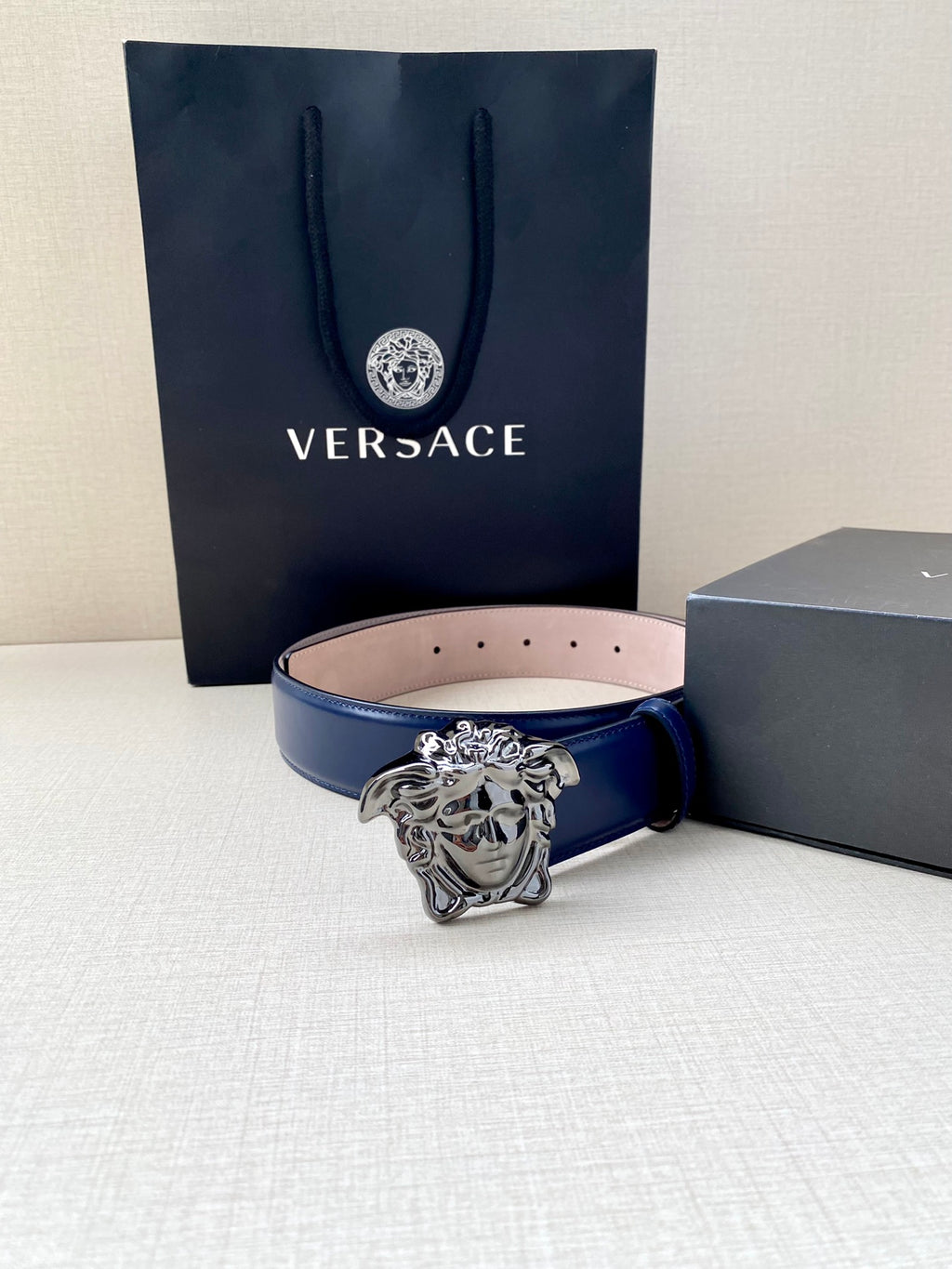 Blue leather belt with silver lion-head buckle and inner pink strap
