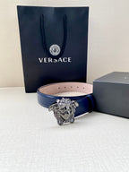 Blue leather belt with silver lion-head buckle and inner pink strap