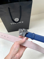 Blue leather belt with silver lion-head buckle and light pink lining, holes shown