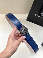 Blue leather belt close-up with silver lion-head buckle and stitched edge