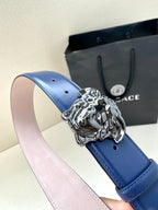 Blue leather belt with silver lion-head buckle and light pink underside