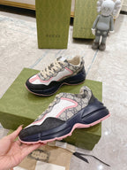 Gucci unisex lace-up sneakers, GG pattern upper, white/pink panels, thick navy sole.