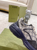 Gucci unisex sneaker close side view, GG monogram upper with navy sole