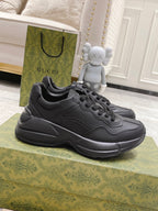 Chunky lace-up sneakers by Gucci, dark/black leather-look with sculpted sole