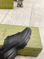 Dark/black Gucci sneaker toe and side, lace-up with stitched panels and sculpted sole