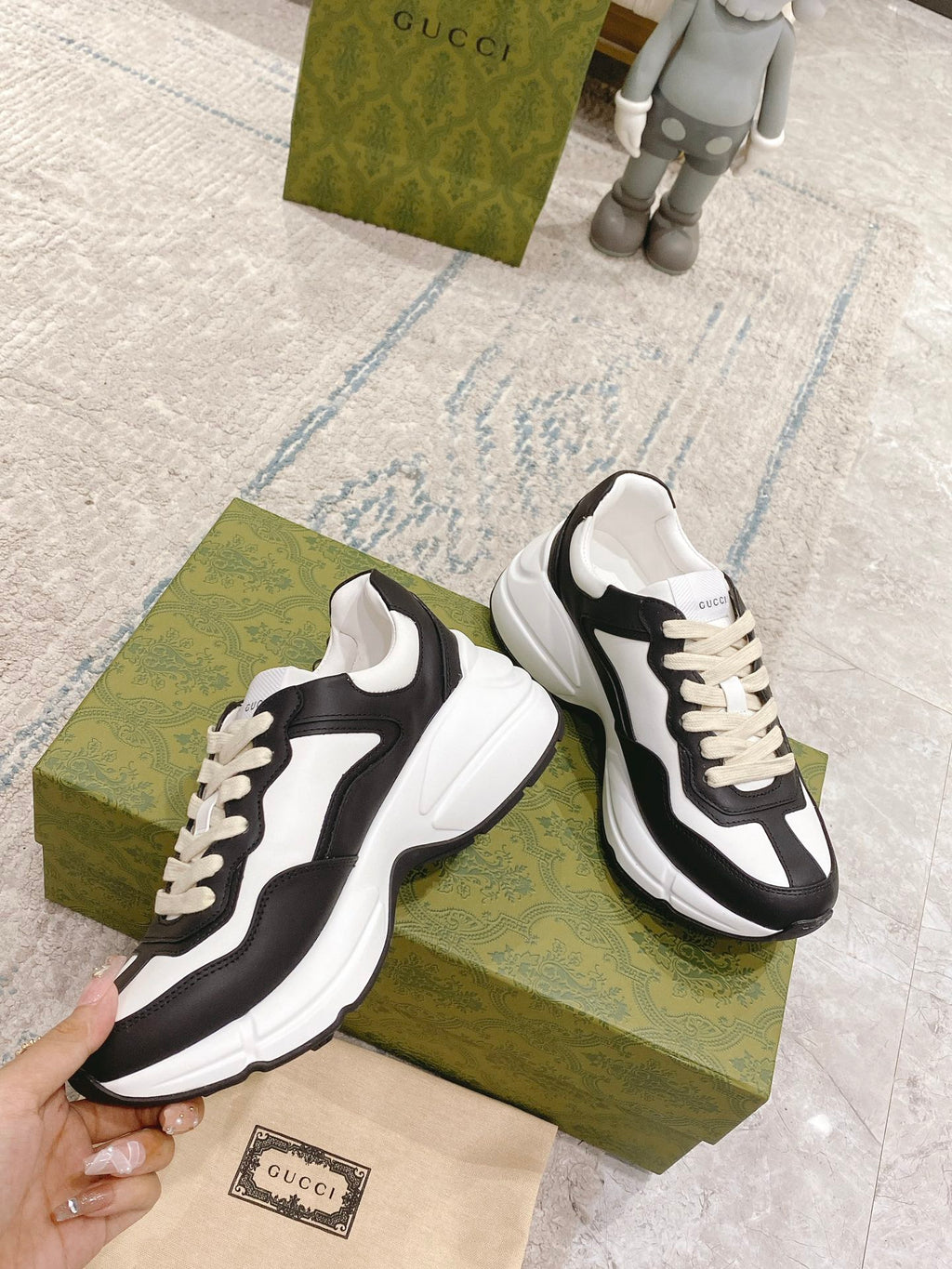 Unisex low-top sneakers in black and white, angled side view with laces