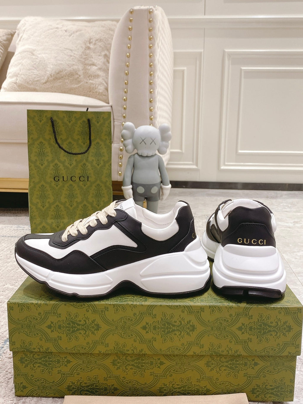 Black and white unisex sneakers set, front and back views on the box