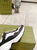 Unisex sneakers, black and white design with cream laces and bold sole