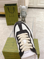 Unisex sneakers, black and white upper with cream laces and round toe