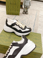 Two black and white unisex sneakers on display, showing side profiles