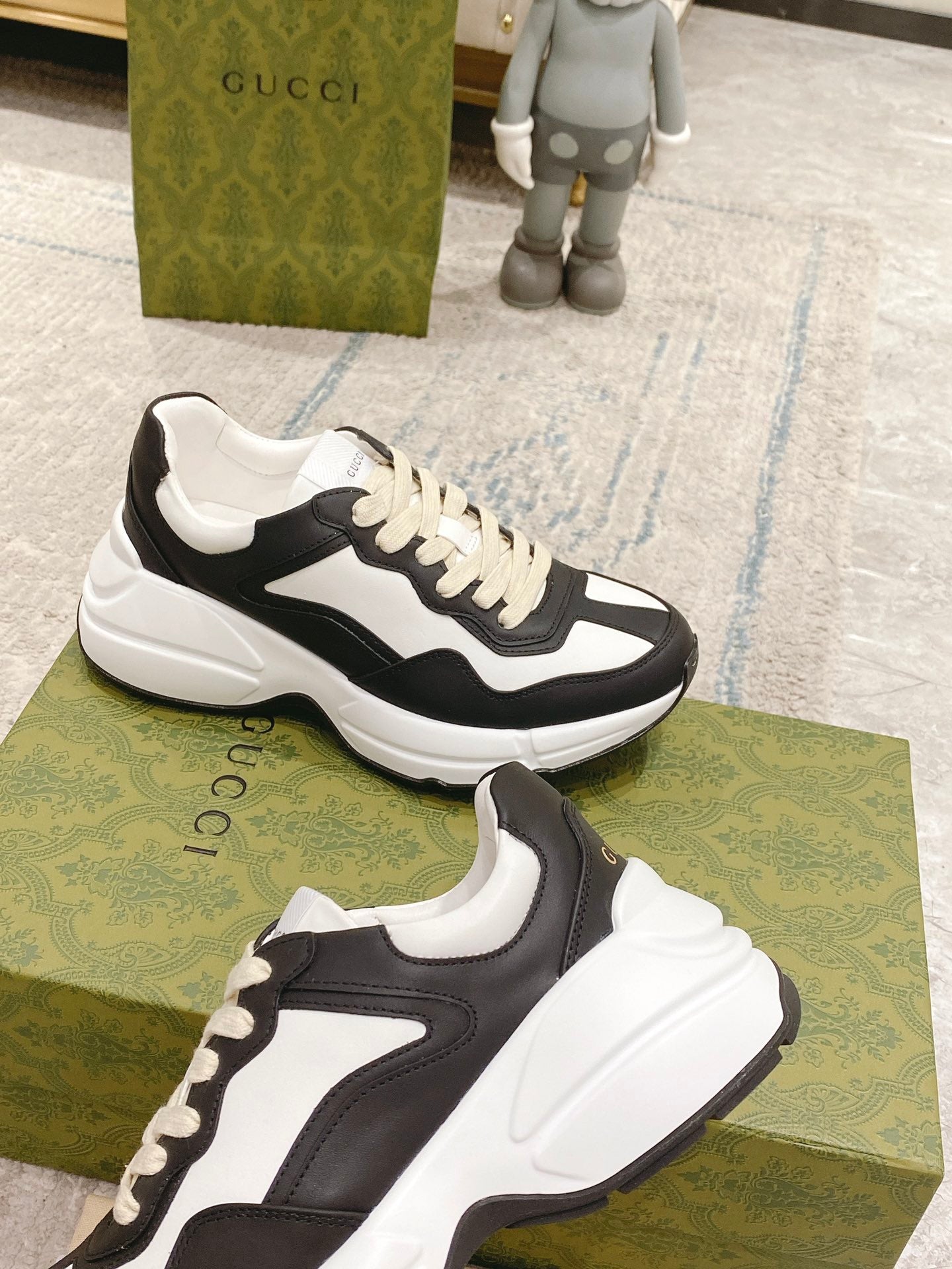 Two black and white unisex sneakers on display, showing side profiles