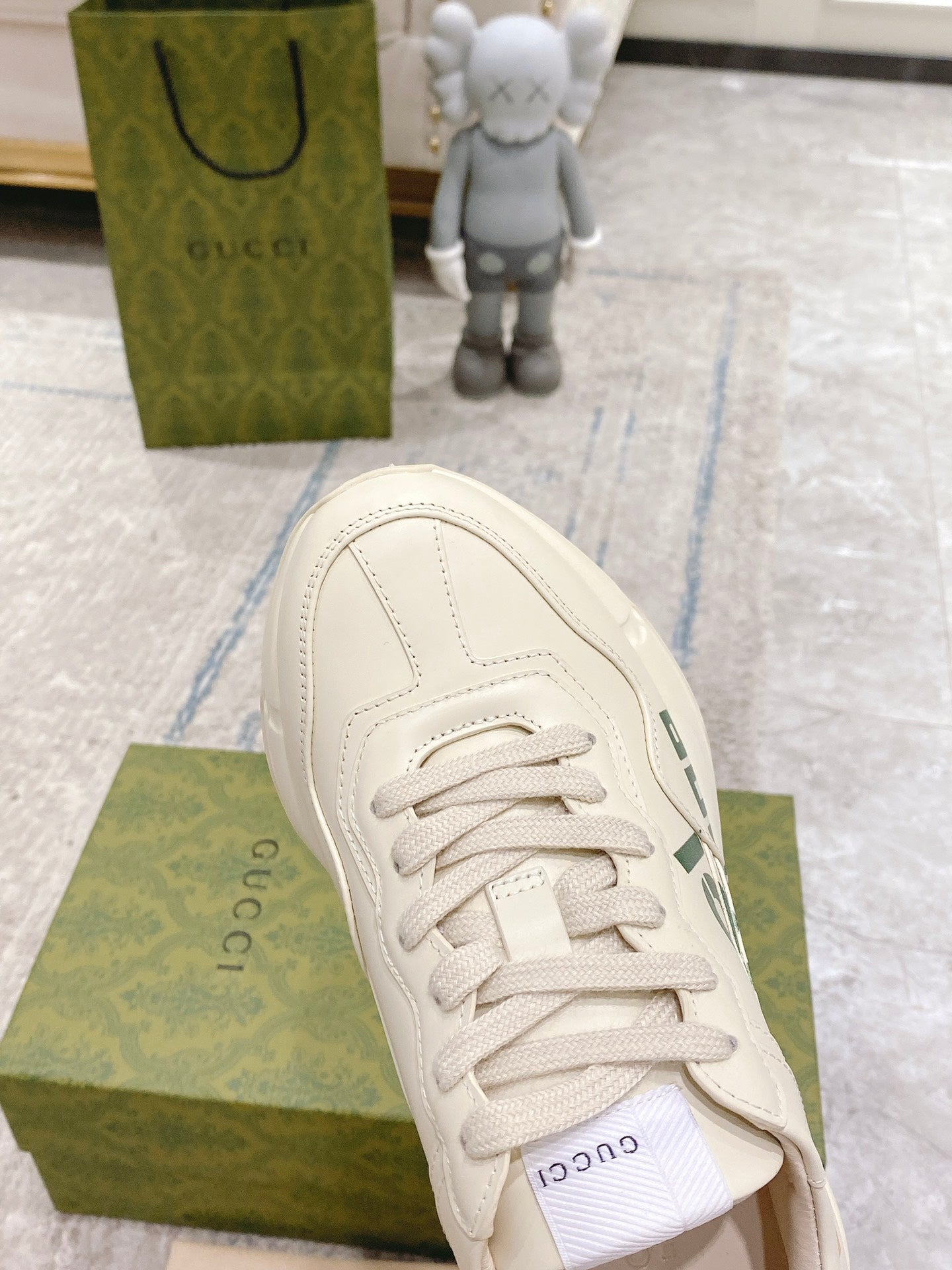 Gucci unisex sneakers, white leather, side close-up of lace-up and stitching