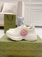 White Gucci unisex sneakers with colorful heart stud logo on the side