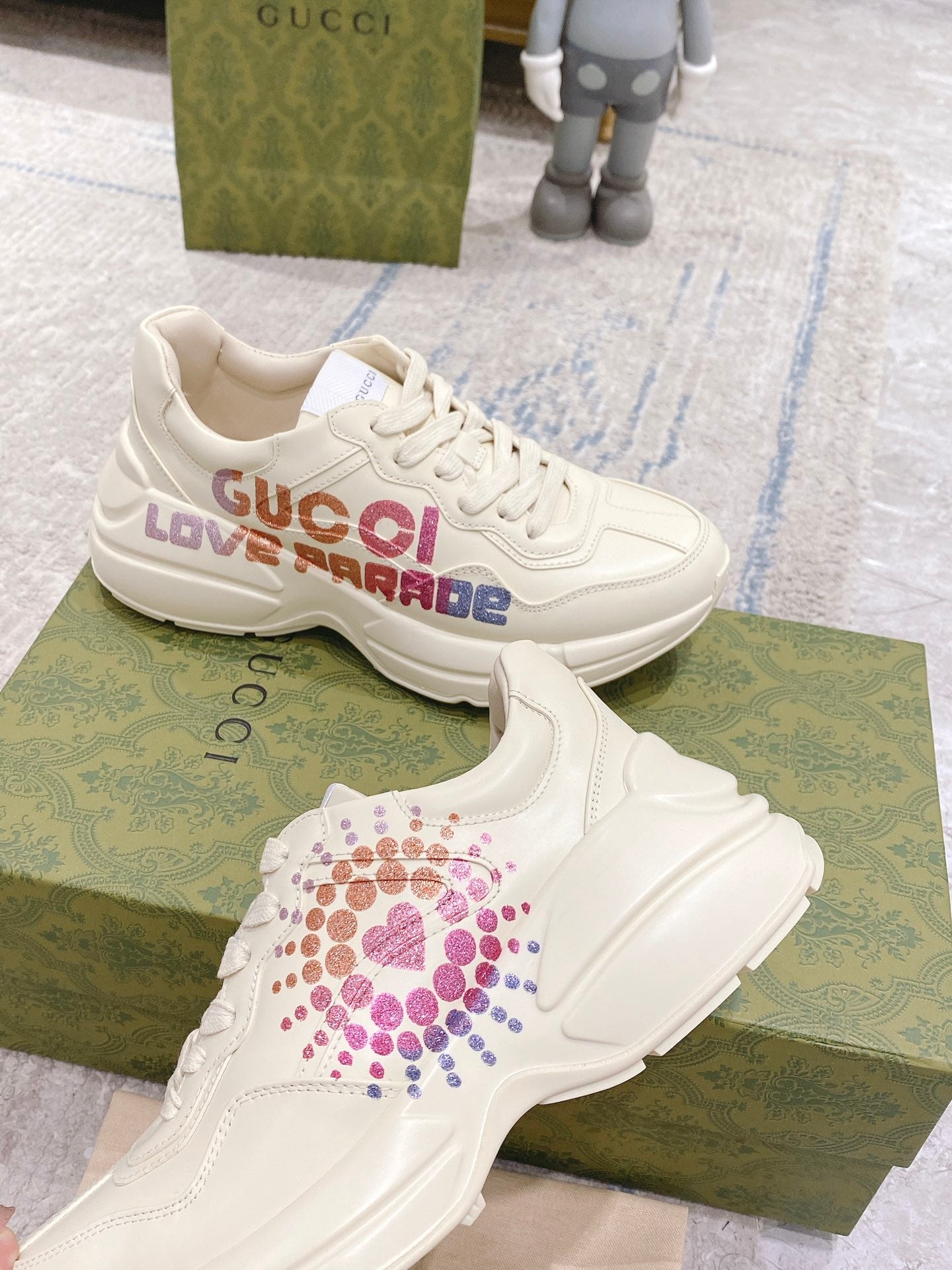 White Gucci unisex sneakers with LOVE PARADE logo across the side panel
