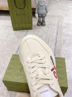 White Gucci unisex sneaker toe view with laces and side graphic detail
