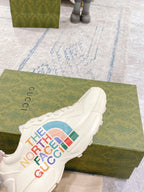 White lace-up sneaker with The North Face Gucci multicolor logo on side