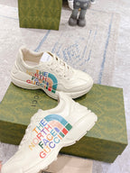 White lace-up sneakers with The North Face Gucci multicolor logos on sides