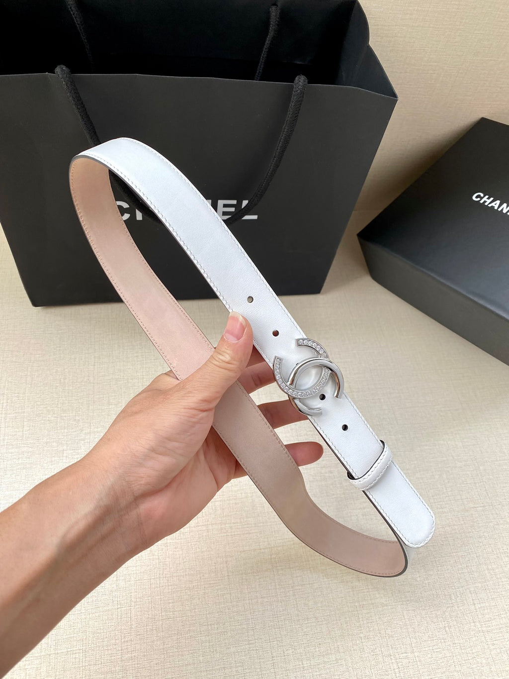 White leather belt with silver CC buckle, punched holes and pin clasp