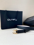 Chanel leather belt with dark blue strap and gold CC buckle, laid flat