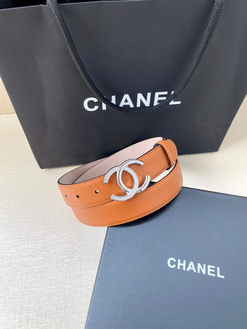 Orange leather belt with silver double-C buckle, featuring punched holes and smooth edge