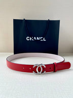 Red leather belt with silver-tone CC buckle, light pink underside, adjustable pin holes.