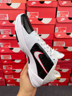White and black high-top sneakers with red swoosh stripe and white rubber sole