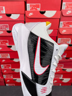 White and black high-top sneakers with red swoosh stripe detail on side