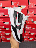 White and black high-top sneakers with red swoosh and black side panel