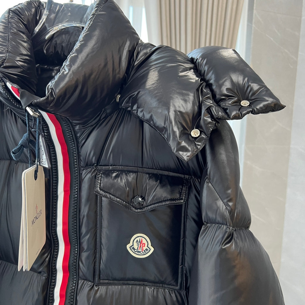 Long puffer jacket sleeve and chest pocket with circular logo and striped trim