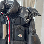 Long puffer jacket sleeve and chest pocket with circular logo and striped trim