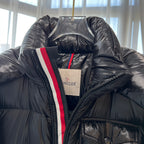 Long puffer jacket front with hood lining, front zip and red-white stripe trim