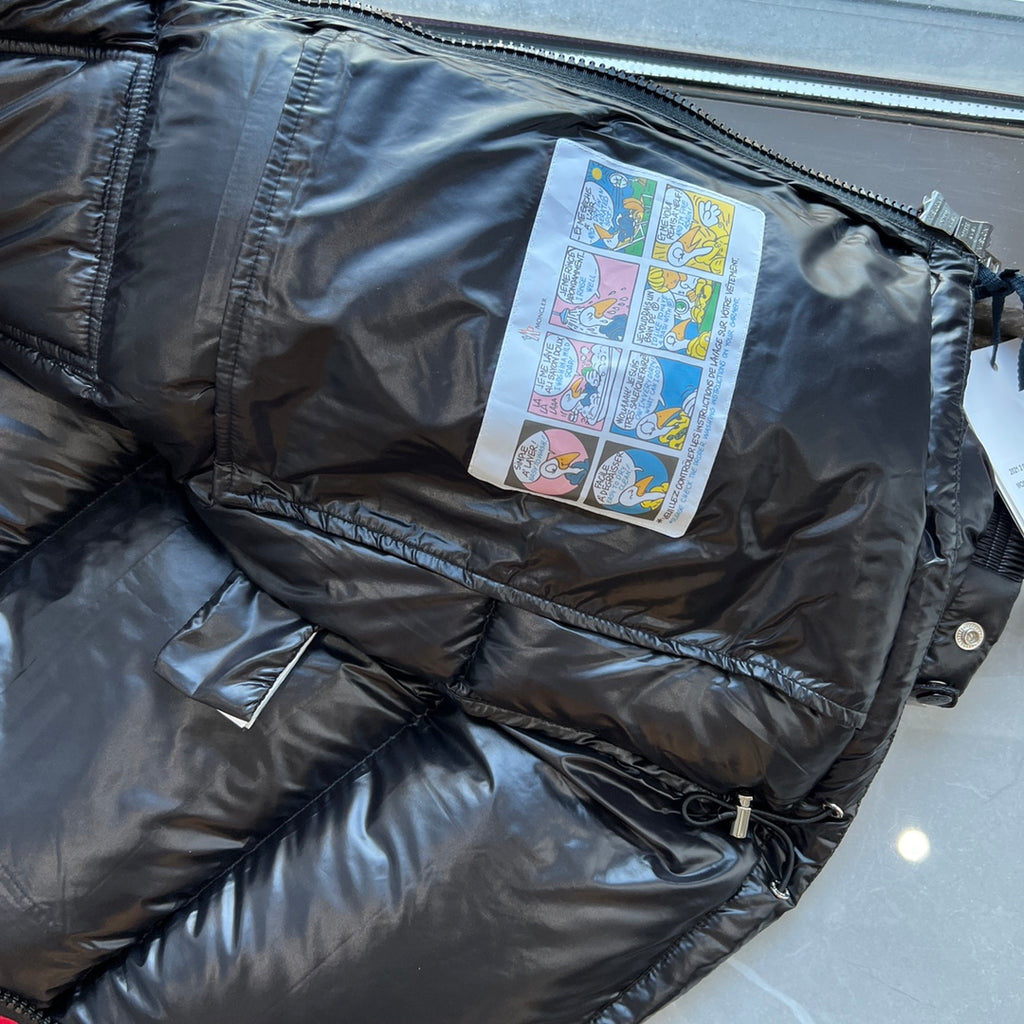 Long puffer jacket interior label patch visible near zipper opening