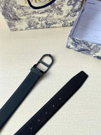 Dior belt detail with dark blue strap, black buckle ring, and hole row