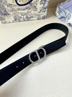 Dior belt close-up showing dark blue textured strap and black buckle plate