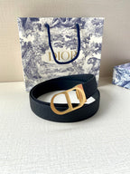 Dior belt coiled in dark blue with gold buckle centerpiece on textured strap