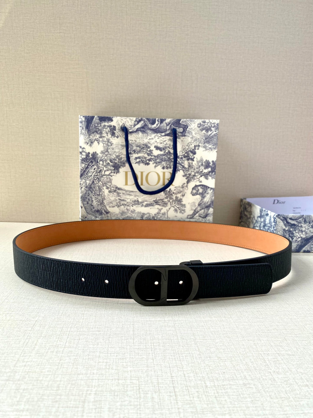 Dior belt with dark navy textured strap and black buckle center ring