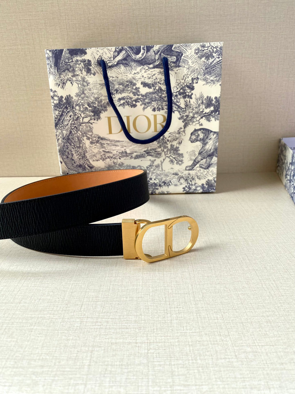 Dior belt with dark navy strap and gold buckle with open center