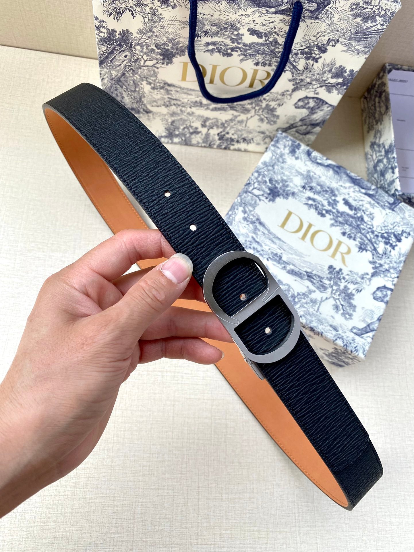 Dior belt with dark navy textured strap and silver double-stud buckle