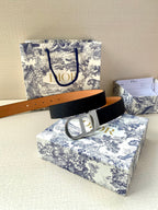 Dior belt with dark navy textured strap and silver-toned buckle, flat lay