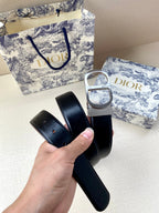 Dior belt with black strap and silver-tone buckle, folded view in hand