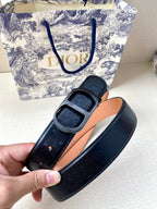 Dior belt detail: black strap with tan lining and gold-tone buckle