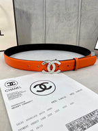 Orange leather belt with gold Chanel CC buckle and black underside strap