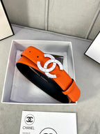 Orange leather belt with gold CC buckle, black underside visible