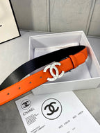 Orange belt with gold CC buckle and black backing on leather strap