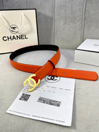 Orange leather belt with gold Chanel CC buckle and black underside
