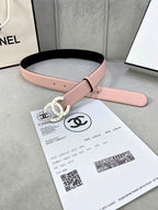 Pink leather Chanel belt with gold-tone double-ring logo buckle on packaging card.