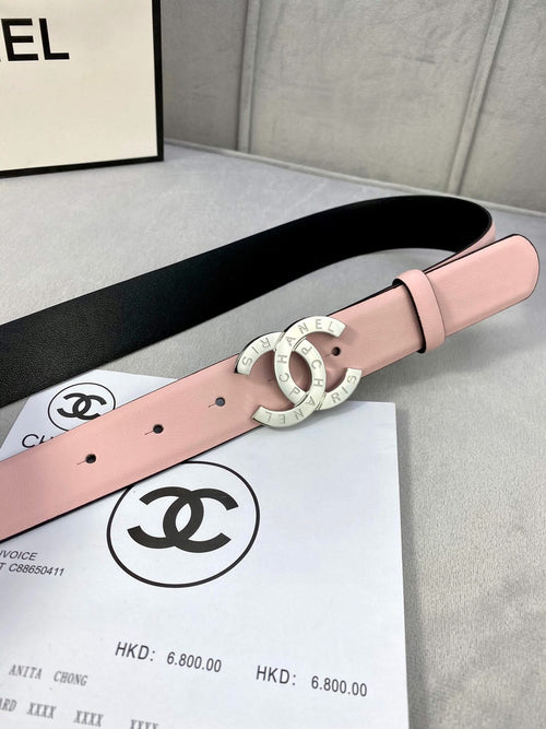 Pink leather belt close-up with gold-tone double-ring Chanel logo buckle.