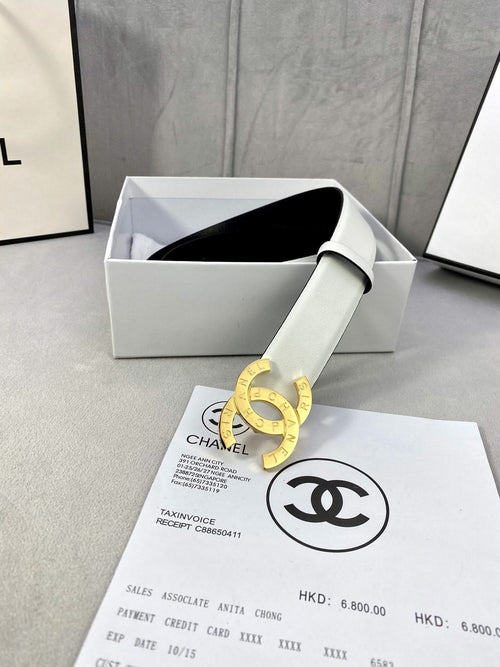 Chanel belt in pale white leather with gold CC buckle, shown in gift box