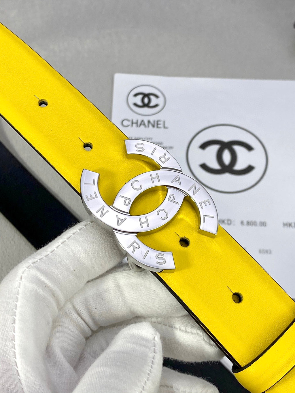 Yellow belt close-up with gold-tone CC buckle and black backing