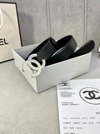 Black leather belt with silver CC buckle in a white box